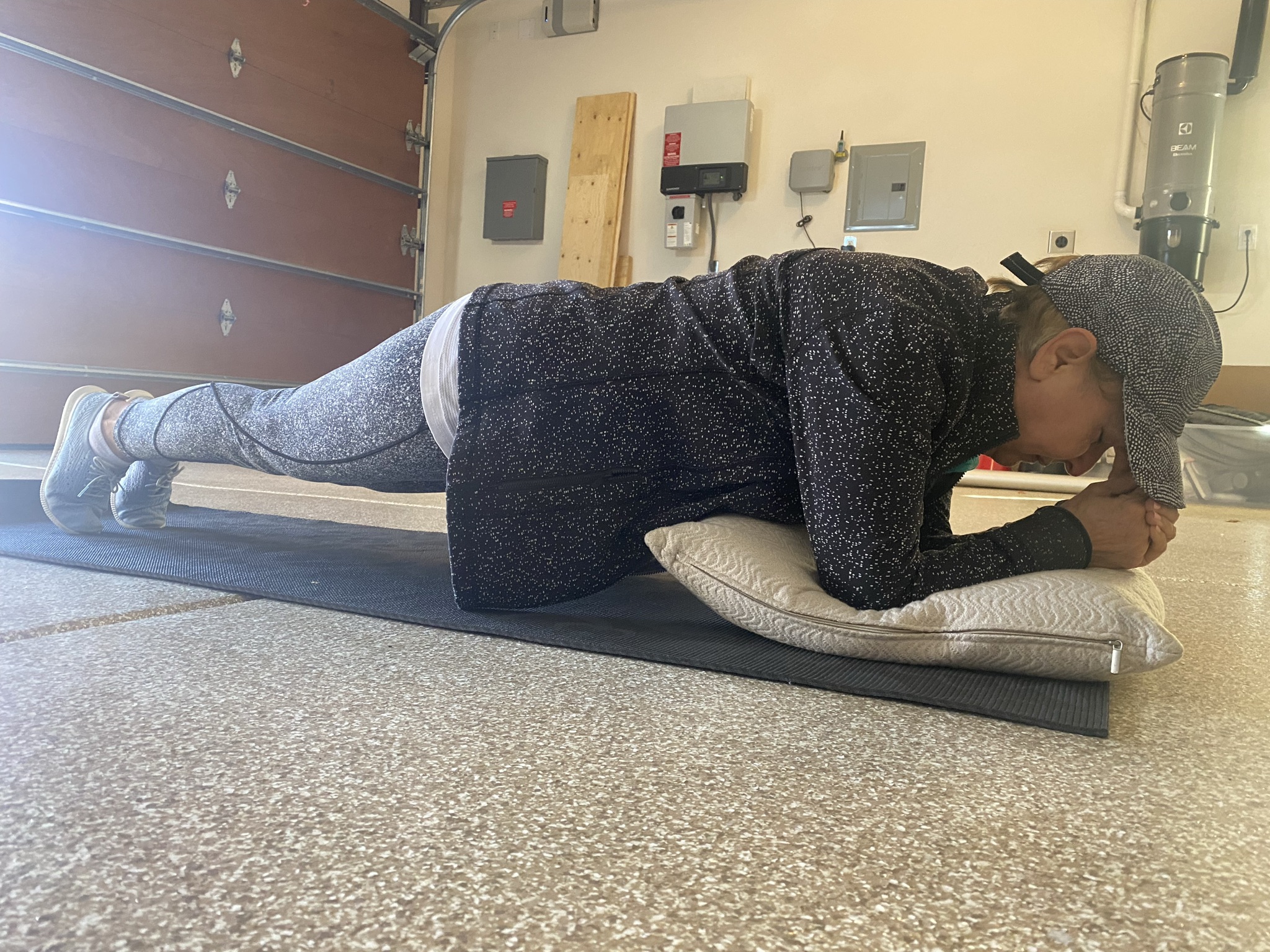 72-year-old woman holding a forearm plank during a personal training session