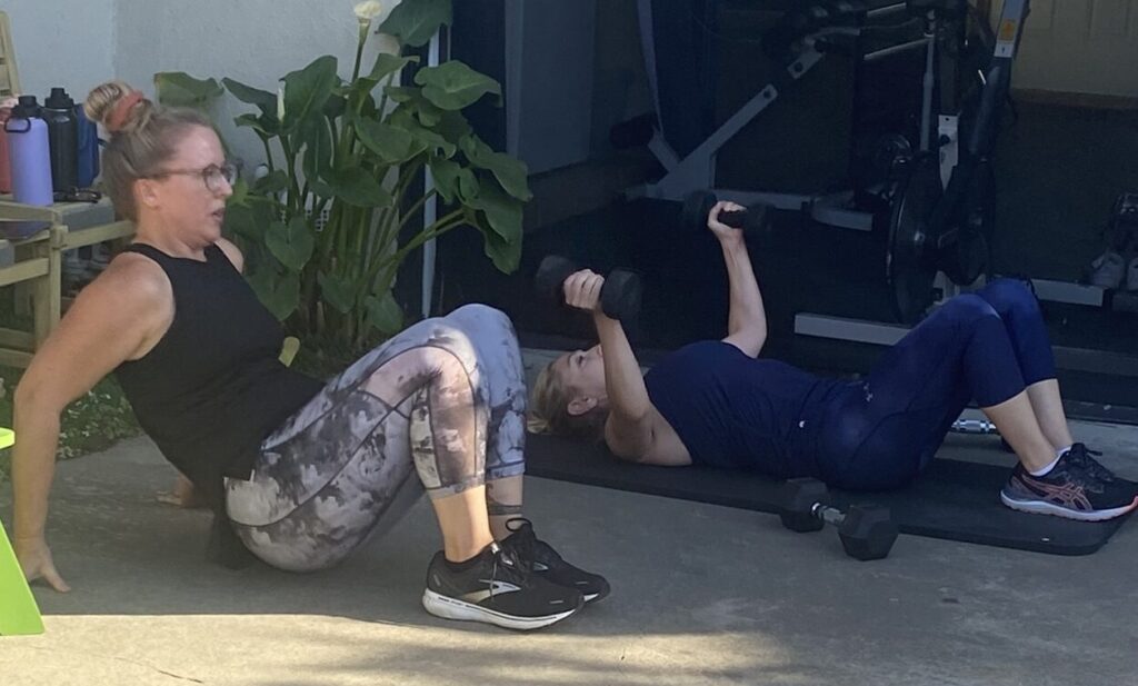 Women over 40 performing strength and mobility exercises during an outdoor training sessio