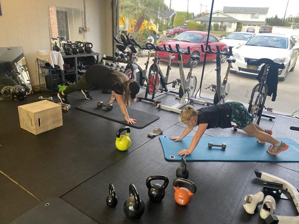 Mother and young daughter working out together. 